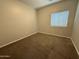 This bedroom features neutral walls, carpet and a window to let in natural light at 1736 W Pollack St, Phoenix, AZ 85041
