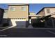 Charming two-story townhome featuring a white garage door, complemented by tidy landscaping and a private entrance at 1736 W Pollack St, Phoenix, AZ 85041