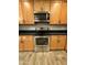 Stainless steel microwave and oven complemented by ample wood cabinetry at 1736 W Pollack St, Phoenix, AZ 85041