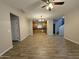 Open-concept living area with wood-look tile flooring that flows into the kitchen with modern stainless steel appliances at 1736 W Pollack St, Phoenix, AZ 85041