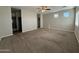 Expansive main bedroom with two windows and neutral carpeting and an attached bath at 1736 W Pollack St, Phoenix, AZ 85041
