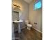 Powder room featuring a pedestal sink, a toilet, and updated fixtures at 1736 W Pollack St, Phoenix, AZ 85041