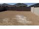 A large backyard with dirt and a block wall at 18232 W La Senda Dr, Surprise, AZ 85387