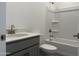 Bathroom featuring gray vanity, tub, shower, and toilet at 18232 W La Senda Dr, Surprise, AZ 85387