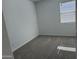 A bedroom with gray carpet and a window with white blinds at 18232 W La Senda Dr, Surprise, AZ 85387