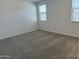 A bedroom with gray carpet and two windows with white blinds at 18232 W La Senda Dr, Surprise, AZ 85387