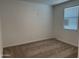 Bedroom features neutral carpeting, a window with blinds, and an electrical outlet at 18232 W La Senda Dr, Surprise, AZ 85387