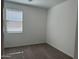 A bedroom with gray carpet and a window with white blinds at 18232 W La Senda Dr, Surprise, AZ 85387