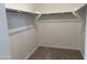 A closet with shelving and gray carpet at 18232 W La Senda Dr, Surprise, AZ 85387
