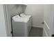 Convenient laundry room with side by side washer and dryer hookups and shelving at 18232 W La Senda Dr, Surprise, AZ 85387