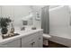 Well-lit bathroom featuring a vanity with ample counter space and a shower-tub combination at 20312 W Sells Dr, Buckeye, AZ 85396