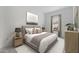 Comfortable bedroom with neutral tones, a cozy bed, and a side table with lamps at 20312 W Sells Dr, Buckeye, AZ 85396