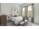 Inviting bedroom featuring neutral tones, a comfortable bed, and natural light from large windows at 20312 W Sells Dr, Buckeye, AZ 85396