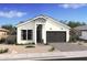 Charming single-Gathering home with gray roof, complemented by desert landscaping at 20312 W Sells Dr, Buckeye, AZ 85396