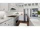 Modern kitchen showcasing stainless appliances, white cabinetry, and stylish backsplash at 20312 W Sells Dr, Buckeye, AZ 85396