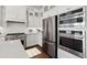 Elegant kitchen with stainless steel appliances, white cabinets, and ample counter space at 20312 W Sells Dr, Buckeye, AZ 85396