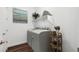 Well-lit laundry room with a side-by-side washer and dryer and decorative wall art at 20312 W Sells Dr, Buckeye, AZ 85396
