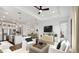 Bright and open living room featuring a ceiling fan and a seamless flow to kitchen and dining at 20312 W Sells Dr, Buckeye, AZ 85396