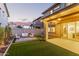 Wonderful backyard featuring a covered patio, an expansive lawn, and an intimate seating area for outdoor gatherings at 2067 N Marketside Ave, Buckeye, AZ 85396