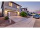 A modern two-story home featuring a two-car garage, well-manicured landscaping, and inviting curb appeal at 2067 N Marketside Ave, Buckeye, AZ 85396