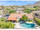Breathtaking aerial shot of a home with a red tile roof, complemented by a pool, patio, and lush greenery at 2236 E Sierra St, Phoenix, AZ 85028