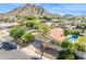 Scenic aerial view of a home with a red tile roof, lush trees, and mountain views, set in a quiet neighborhood at 2236 E Sierra St, Phoenix, AZ 85028