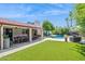 Charming backyard featuring lush grass, a refreshing pool, and comfortable patio seating under a covered area at 2236 E Sierra St, Phoenix, AZ 85028