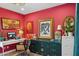 Vibrant home office space with red walls, unique art pieces, and ample desk space at 2236 E Sierra St, Phoenix, AZ 85028