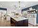 Gourmet kitchen featuring a marble island, white cabinets, and stainless steel appliances at 2236 E Sierra St, Phoenix, AZ 85028