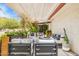 Charming patio with white pergola, stylish outdoor furniture and beautiful landscaping at 2236 E Sierra St, Phoenix, AZ 85028