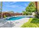 Inviting pool area with mature landscaping and a stylish privacy fence, perfect for relaxation and outdoor enjoyment at 2236 E Sierra St, Phoenix, AZ 85028