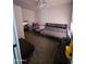 Inviting bedroom featuring a comfortable futon, dining table, and ceiling fan at 2301 E University Dr # 280, Mesa, AZ 85213