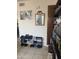 Organized entryway with shoe rack and a unique bat-themed mirror adding character and functionality to the space at 2301 E University Dr # 280, Mesa, AZ 85213