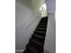 Carpeted staircase leading to the upper level of the home at 2301 E University Dr # 280, Mesa, AZ 85213