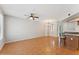 Open-concept living room with wood floors and ceiling fan leading to the kitchen at 2401 E Rio Salado Pkwy # 1047, Tempe, AZ 85288