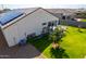Aerial view of the backyard with patio and manicured lawn, highlighting outdoor features at 30128 W Weldon Ave, Buckeye, AZ 85396