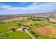 Aerial view of the community ballfields and park with green spaces, perfect for recreational activities at 30128 W Weldon Ave, Buckeye, AZ 85396