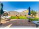 Comfortable outdoor patio with blue umbrella and swing perfect for relaxation at 30128 W Weldon Ave, Buckeye, AZ 85396