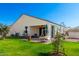 Well-maintained backyard with lush lawn, covered patio, and mature landscaping at 30128 W Weldon Ave, Buckeye, AZ 85396