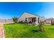 Serene backyard with green lawn, patio, and privacy wall offers a peaceful outdoor space at 30128 W Weldon Ave, Buckeye, AZ 85396