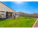 Expansive backyard featuring green lawn and covered patio, perfect for outdoor living at 30128 W Weldon Ave, Buckeye, AZ 85396