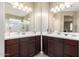 Dual sink bathroom featuring matching mirrors, vanities, and a neutral color palette at 30128 W Weldon Ave, Buckeye, AZ 85396