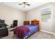 Bedroom with neutral walls, carpeting, and desk with office chair at 30128 W Weldon Ave, Buckeye, AZ 85396