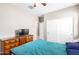 Bedroom featuring neutral walls, carpeting, wood dresser, and a ceiling fan at 30128 W Weldon Ave, Buckeye, AZ 85396