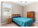 Cozy bedroom with a window providing natural light and a wood dresser at 30128 W Weldon Ave, Buckeye, AZ 85396