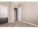 Neutral carpeted bedroom offers a versatile space with a bright ceiling fixture at 30128 W Weldon Ave, Buckeye, AZ 85396