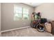 Inviting bedroom with a large window, neutral walls, and carpeting, offering comfort at 30128 W Weldon Ave, Buckeye, AZ 85396