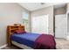 Comfortable bedroom features a cozy bed, closet, and a bright window for natural light at 30128 W Weldon Ave, Buckeye, AZ 85396