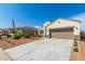 Charming single-story home with a two-car garage, low maintenance landscaping, and a well-lit exterior at 30128 W Weldon Ave, Buckeye, AZ 85396