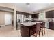 Modern kitchen with stainless steel appliances, dark wood cabinets, and granite countertops at 30128 W Weldon Ave, Buckeye, AZ 85396